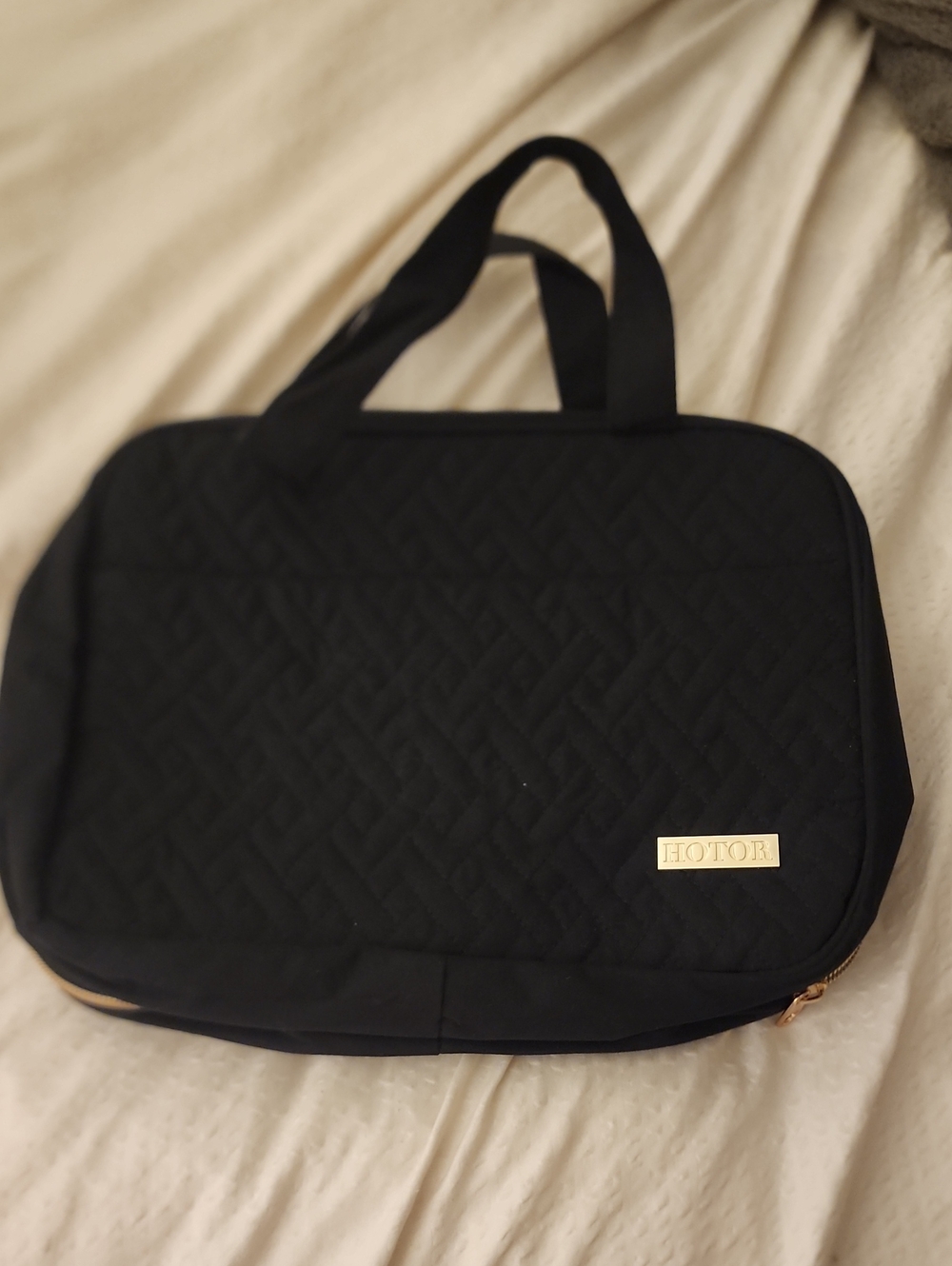 Black Quilted Travel Toiletry Bag. Hanging.